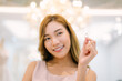 © kelvn - Attractive young bride is smiling and bride holding a ring in modern wedding salon.