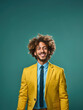 © IBEX.Media - Studio portrait of Confident young man in yellow blazer smiling wide