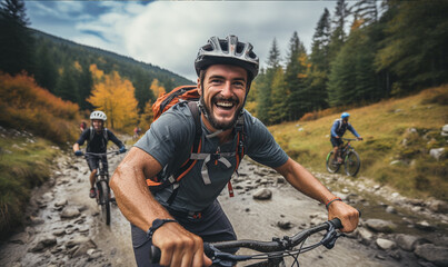 Young man smiles into the camera as he rides up extreme mountain bike.