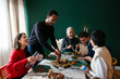 © Westend61 - Multiracial family laughing and enjoying dinner at home