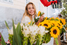 Happy Woman Buying Yellow Sunflowers In Market
