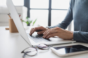 man hands typing on computer keyboard closeup, businessman or student using laptop at office, online