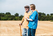 © Westend61 - Healthcare worker holding hand of elderly man and walking by field