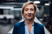 Smiling Businesswoman With Short Blond Hair At Work Place