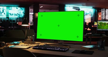 Leinwandbilder - Empty Office of Creative Agency with Art on Walls and Desks with Computers. Office Space with Digital Green Screen Mock Up Chroma Key Monitor Standing at Night on Developer's Table. Zoom Out