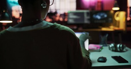 Poster - Dolly Backview: Motivated Black Female Using Laptop and Tablet Computer in Creative Agency in the Evening. Dedicated Woman Working in a Creative Job Position in an Advertising Company