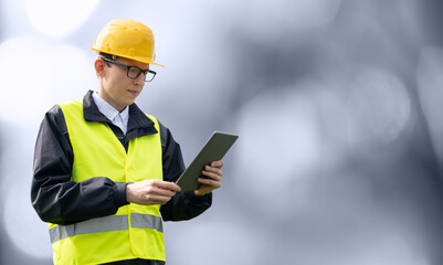 Poster - Portrait of a smiling engineer in a glasses, helmet and blue suit looking at camera. Isolated.