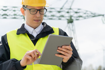 Poster - Engineer with digital tablet on a background of power line tower.