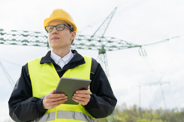 Aufkleber - Engineer with digital tablet on a background of power line tower.