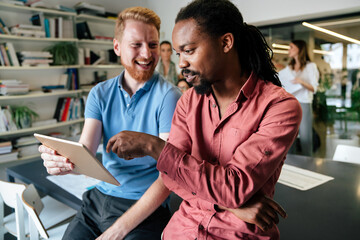 Sticker - Smiling diverse colleagues gather in boardroom brainstorm discuss financial statistics together