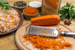 Grated raw carrots, grater, sauerkraut, parsley and spices.