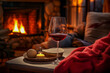 © Anna - Relaxing by the fireplace. A glass of red wine, candles and a blanket. Warm cozy atmosphere in winter time. Holiday concept.