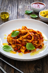 Wall Mural - Tagliatelle con ragù alla bolognese - pasta with minced meat and tomato sauce on wooden table