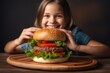 young child eating hamburger