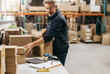 © Jacob Lund - Senior warehouse worker packing orders