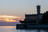 Fototapeta  - Beautiful sunset light at Langenargen with silhouette of castle Montfort Bodensee