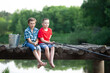 Children on a fishing trip. The boys are fishing with a fishing rod in the lake.
