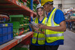 © Nassorn - Multiracial manager train female technician working job in warehouse and logistic professional occupation. Storehouse supervisor and woman team talking discussing inventory storage or order delivering