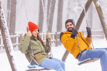 Wall Mural - Couple swinging while on winter vacation