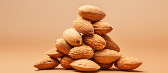 Poster - Almonds stacked against a isolated pastel background Copy space