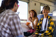 © CandyRetriever  - Group of Asian people friend enjoy and fun outdoor lifestyle travel in Thailand by railroad transportation on summer holiday vacation. Happy man and woman friends sitting on train and talking together