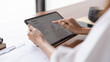 © snowing12 - Closeup hands of businesswomen using tablet to reading finance data and analysis about new startup