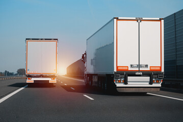 Wall Mural - Two modern semi-trailer trucks on the highway driving and overtaking each other. Commercial vehicle for shipping and post delivery. Shipping of the goods on land door-to-door