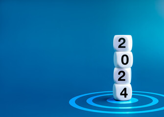 Poster - 2024 Happy New year banner. 2024 year numbers on white dice cube blocks stacked on target dart icon on blue background with copy space. Start a growth business with goal and success concept.
