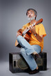 © luengo_ua - Aged bearded man with an acoustic guitar