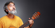 © luengo_ua - Aged bearded man with an acoustic guitar