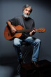 © luengo_ua - Aged bearded man with an acoustic guitar