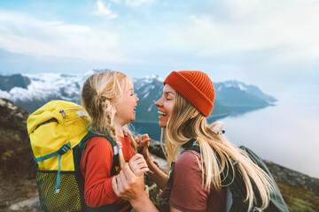 Wall Mural - Mother playing with daughter child outdoor hiking in Norway together happy family lifestyle traveling in mountains active vacations woman laughing with kid Mother's day holiday