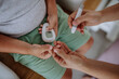 © Halfpoint - Mother checking her son's blood glucose level at home using a fingerstick glucose meter.