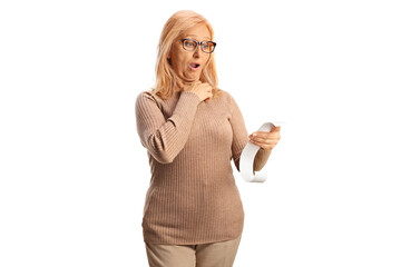 Canvas Print - Shocked mature woman holding a bill