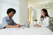 © DragonImages - Positive product manager working in light modern office