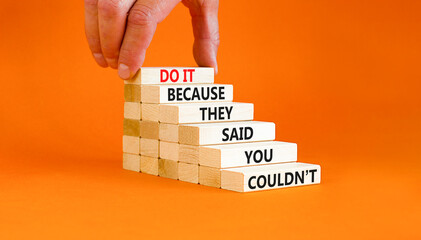 Wall Mural - You can do it symbol. Concept words Do it because they said you could not on wooden block. Beautiful orange table background. Businessman hand. Business, motivational you can do it concept. Copy space
