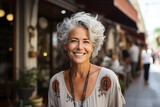 Fototapeta  - portrait of a beautiful elderly woman with white gray hair against the background of a restaurant in the city, smiling