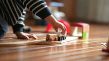Close-up Of Kid's Hand With Retro Toy Railroad, Boy Playing With Vintage Train Set At Home