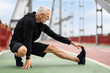 © Prostock-studio - Athletic elderly sportsman strecthing legs, have outdoor workout