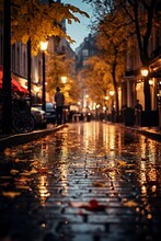 In Heart Of City, On A Dark Autumn Night, A Vertical Photo Captures Enchanting Ambiance Of A Rain-kissed Street, Adorned With Golden Leaves, Evoking An Atmospheric And Tranquil Urban Scene.
