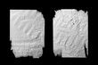 Two sheets of white torn paper with folds isolated on a black background.