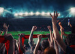 © alphaspirit - Football scene at night match with with cheering fans at the stadium