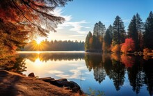 A Scenic Landscape With A Tranquil Lake Surrounded By Trees In Their Fall Colors, Capturing The Reflective And Peaceful Ambiance That Autumn Brings To Natural Settings