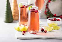 Festive Christmas Mimosa Cocktail With Cranberry Juice And Lime Zest