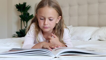 Wall Mural - Bedroom, reading girl book in home for story time, child development and learning. Education, relax kid laying in bed with books fantasy, storytelling and literature hobby. International literacy day