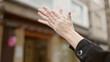 © Krakenimages.com - Young beautiful hispanic woman clapping applause at street