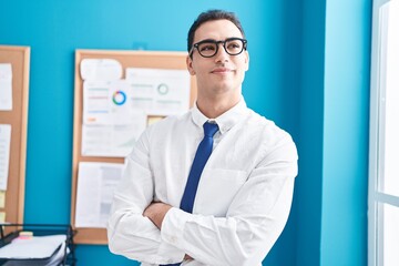 Sticker - Young hispanic man business worker standing with arms crossed gesture at office