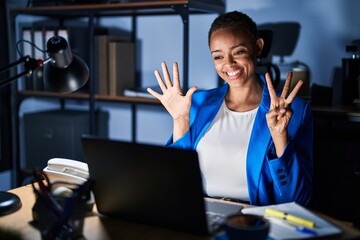 Sticker - Beautiful african american woman working at the office at night showing and pointing up with fingers number eight while smiling confident and happy.