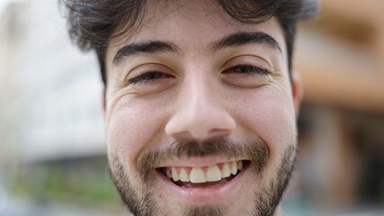 Sticker - Young hispanic man smiling confident standing at street