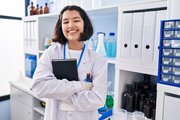 Sticker - Young hispanic woman working at scientist laboratory smiling with a happy and cool smile on face. showing teeth.